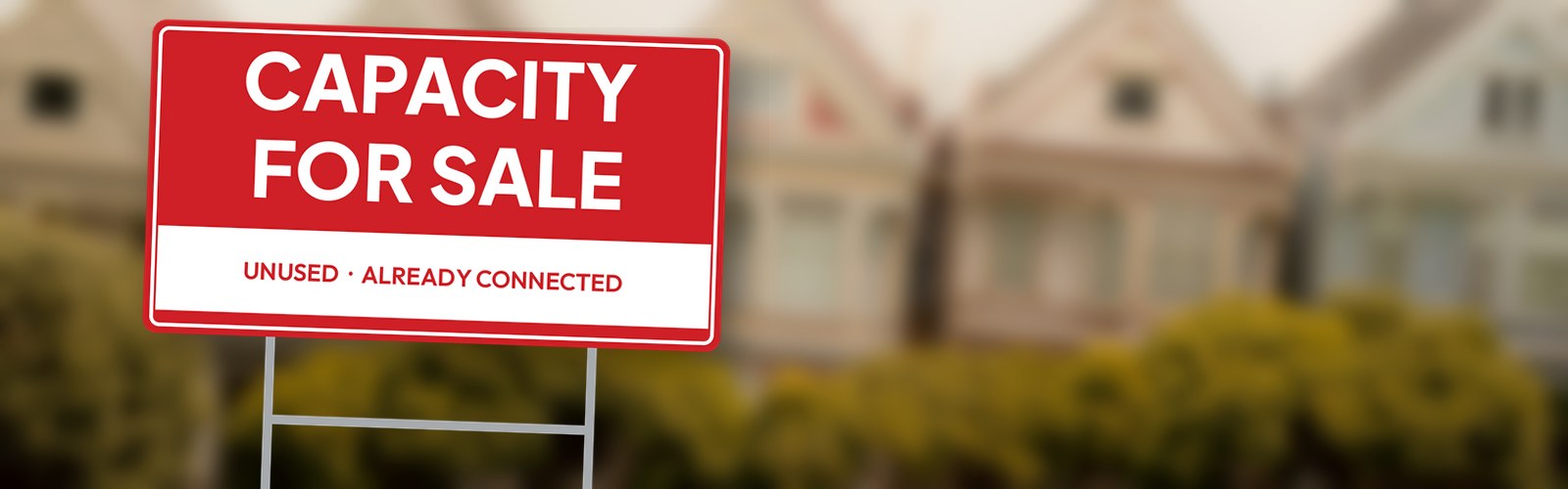 A yard sign reading "Capacity for sale" in front of a row of San Francisco Victorian houses